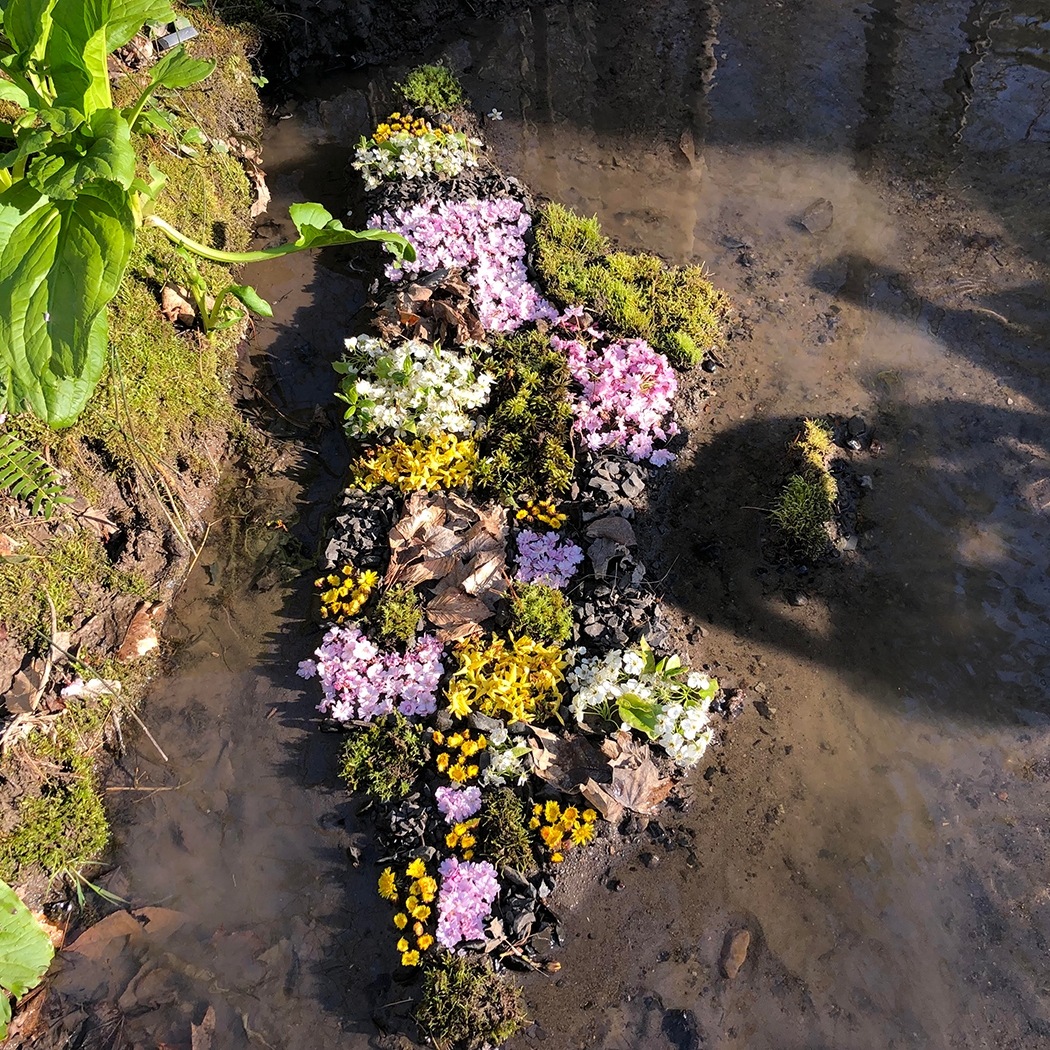 flower sculpture in the earth surrounded by water